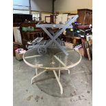 A glass topped garden table and four chairs together with a plant stand