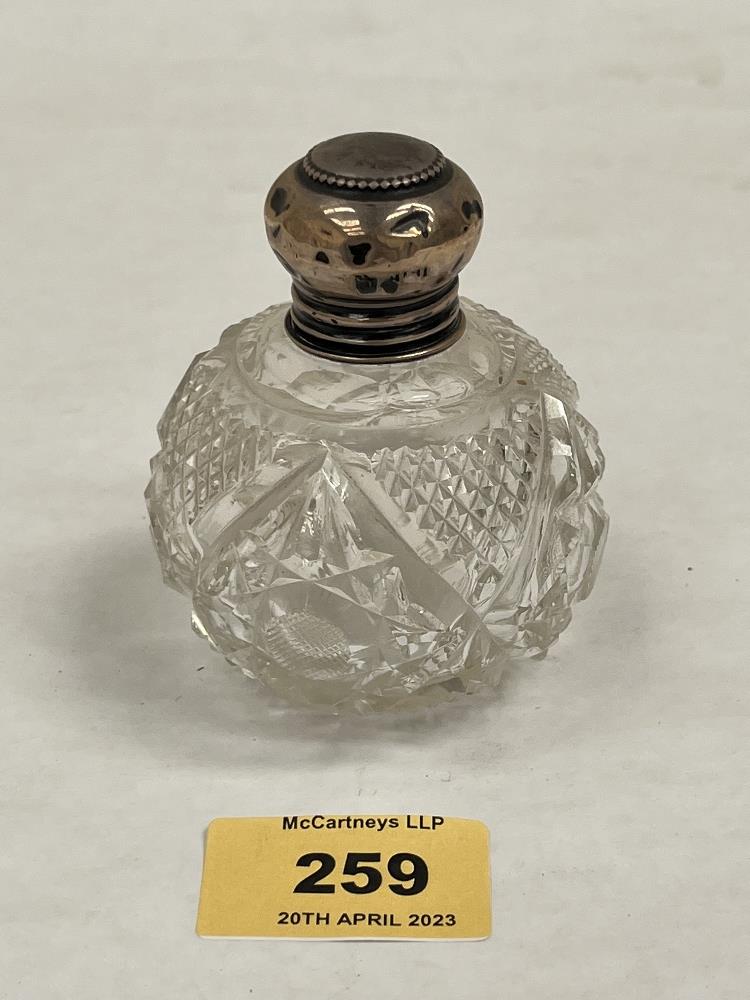 A silver topped cut glass scent bottle with stopper. c.1900. 3¼' high