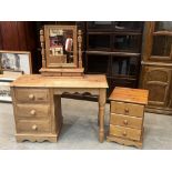 A pine dressing table and a bedside chest