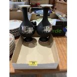 A pair of baluster vases, decorated with classical chariots on a matt black ground. 10¼' high