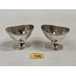 A pair of George V silver salts of ovoid shape with reeded rims. London 1933. 3' wide. 4ozs 10dwts