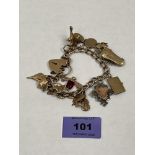 A 9ct charm bracelet with locket clasp and safety chain. 40g approx. excluding one silver charm
