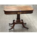 A Regency rosewood cut brass and line inlaid card table on quadripartite outswept support. 36' wide