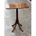 A mahogany and banded occasional table on quadripartite outswept support. 24' high