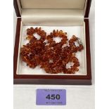 A necklace of amber beads with silver clasp. 26' long. 23.8g