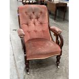 A Victorian walnut and upholstered armchair with deep buttoned back on inverted baluster turned