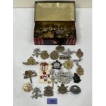 A tin of regimental badges, military buttons etc.