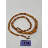 A necklace of graduated amber beads. 24' long. 18g