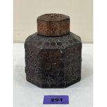 A Chinese octagonal bronzed metal tea caddy and cover, decorated in relief with prunus. 4¼' high