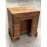A 19th century campaign mahogany kneehole desk with brass carrying handles, on bracket feet. 27'w