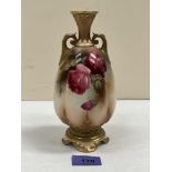 A Royal Worcester inverted baluster two handled vase, gilded and painted with Hadley roses. Shape