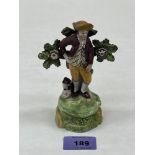 An early 19th century Staffordshire bocage figure of a sheperd (sic) 5¼' high.