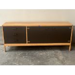 A modernist design teak and lacquered sideboard in the manner of Gordon Russell. 72' wide