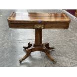 A Regency rosewood cut brass and line inlaid card table on quadripartite outswept support. 36' wide