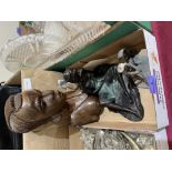 A resinous sculpture; a carved African bust and a metal golfer and caddy group