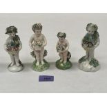 Four 19th century glazed earthenware figures of children with baskets of flowers. 5' high and