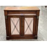 A 19th century mahogany and brass line inlaid side cabinet enclosed by a pair of pleated silk and