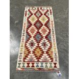 A Chobi Kilim rug. 1.47m x 0.64m