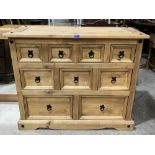 A pine sideboard with an arrangement of nine drawers. 40' wide