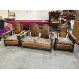 A 1930s oak three piece suite with leather faced reclining backs