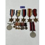 A group of seven WW2 medals with a group of six miniature medals