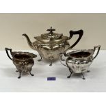 A George V silver three piece tea service by Walker and Hall, to comprise teapot, sucrier and milk