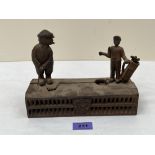 A cast iron golfer and caddy money bank. 8½' wide