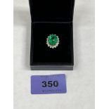 A 9ct green stone and diamond cluster ring. 3g gross. Size M
