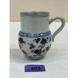 A Chinese Imari decorated mug with reeded neck. 4' high. Rim chip