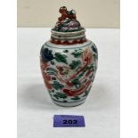 A Chinese famille-verte ovoid jar and associated cover, painted with dragons and foliage. 5' high.