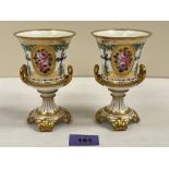A pair of Royal Crown Derby campana vases, gilded and painted with trees and vignettes of roses.