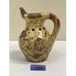 A late 18th century Donyatt glazed earthenware puzzle jug, sgraffito decorated and dated 1795.