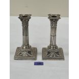 A pair of Victorian Adam revival columnar candlesticks, the downswept square bases with ribbon-tie