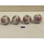 A set of four late 19th century ceramic carpet bowls decorated with flower sprays. 3¼' diam approx.