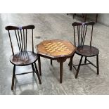 A walnut and inlaid chessboard topped table and a pair of stickback chairs