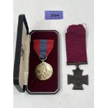A replica Victoria Cross medal and an Elizabeth II For Efficient Service medal