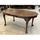 A 1920s mahogany dining table on shell moulded turned tapered legs with hairy paw feet. 70' long