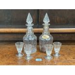 A pair of 19th century mallet shaped decanters, 12' high with a set of four Victorian wine glasses