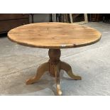 A pine table, the round top on quadripartite support. 47' diam