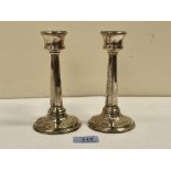 A pair of George V silver candlesticks. London 1922. 6' high. Loaded, dents