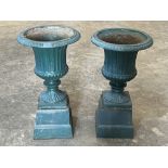 A pair of cast iron campana garden vases on stands. 26½' high