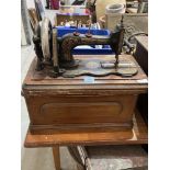 A 19th century oak chest, 27' wide (A.F.) and a sewing machine
