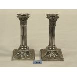 A pair of Victorian Adam revival columnar candlesticks, the downswept square bases with ribbon-tie