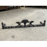 A cast iron fire curb, cast with a basket of fruit and adorsed birds. 56' wide