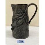 An early 20th century French pewter jug by Albert Chezal, moulded with cherry fruits and foliage.