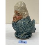 An unusual glazed pottery figure of a bird with human face. 7½' high