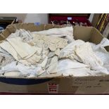 A box of christening gowns; kid gloves; lace and other textiles