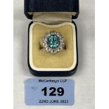 An aquamarine (?) and ten stone diamond cluster ring. In platinum marked PLAT, the centre stone 10mm