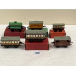 Six Hornby tinplate coaches and trucks, four boxed. 'O' guage