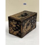 A Japanese black lacquer table chest, the three drawers enclosed by a door, all-over decorated